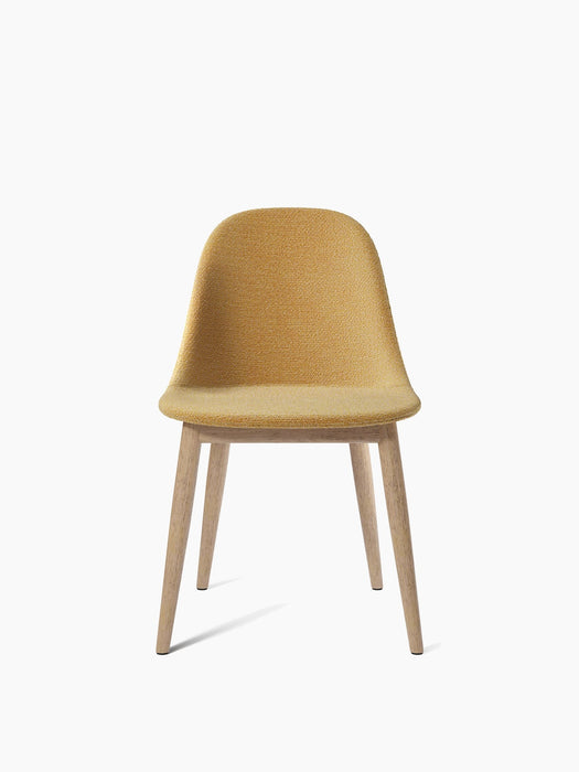 A front view of the Harbour Side Dining Chair with a moss yellow upholstered seat and back, set on a natural oak wooden base.