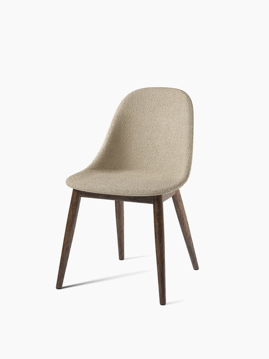 Angled view of the Harbour Side Dining Chair, light beige Audo Bouclé 02 upholstered seat on a dark stained oak base.