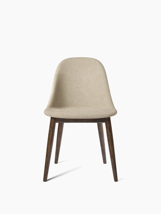 The Harbour Side Dining Chair with a light beige bouclé upholstered seat and a dark stained oak base, seen from the front.