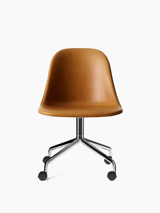 Front view of the Harbour Side Dining Chair upholstered in tan Dakar leather, with polished aluminium star base and casters.