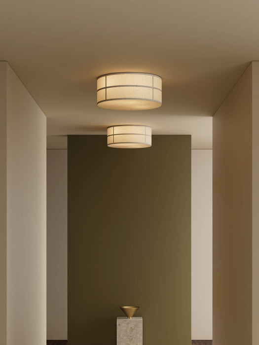 Two illuminated Hashira Ceiling Lamps mounted on the ceiling of a minimalist hallway with neutral and olive-green walls.