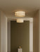 Two illuminated Hashira Ceiling Lamps mounted on the ceiling of a minimalist hallway with neutral and olive-green walls.