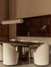 A minimalist dining room with the Hashira Linear Pendant Lamp over an Androgyne Dining Table and white Tearoom Side Chairs.