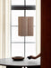 The Hashira Pendant Cluster lamp in Raw linen hangs above a dark wood Androgyne Dining Table with an NNWD Footed Bowl.