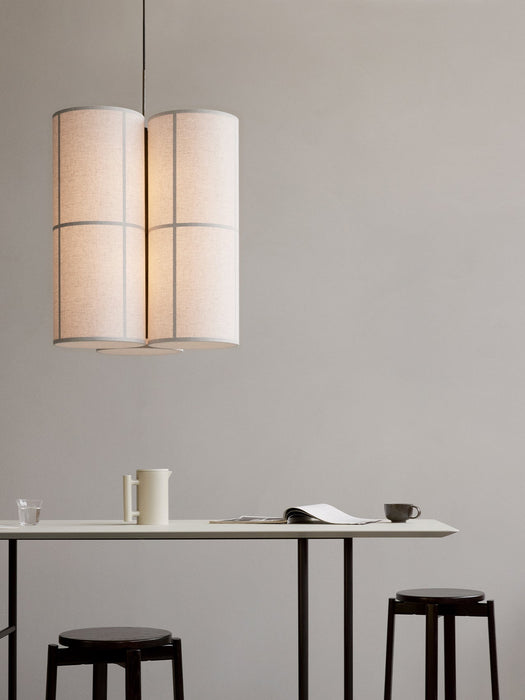 Hashira Pendant Lamp Cluster hangs over a Snaregade Counter Table with Passage Stools, a Yana Brewing Pot, and a magazine.