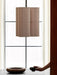 The Hashira Pendant Lamp, Cluster, with three raw linen shades, hangs over a dark table with ceramic bowls by a window.