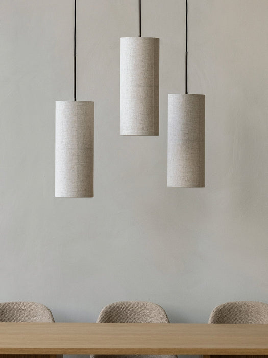 Three Hashira Pendant Lamps hang in a row above the Androgyne Dining Table & Harbour Side Dining Chairs in a minimal setting.