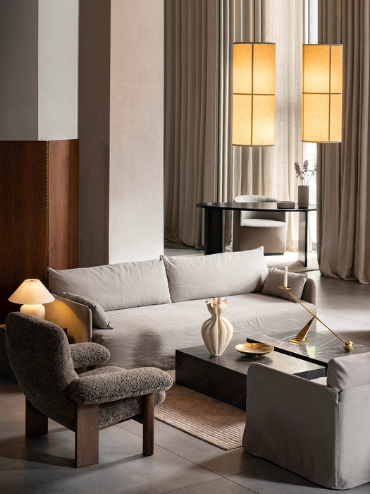 Living room with Offset Sofa, Brasilia Chair, Plinth table with Interconnect Holder, Torso lamp, and Hashira Pendants.