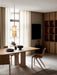 A Hashira Pendant Lamp hangs over an Androgyne Dining Table surrounded by Ready Dining Chairs in a minimalist dining room.