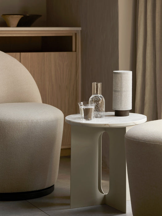 The Hashira Table Lamp, Portable on a marble side table, styled next to a Tearoom Side Chair in a soft, neutral-toned room.