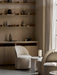 A lit Hashira Table Lamp, Portable, on a side table between two cream Tearoom Side Chairs in a cozy, minimalist room.