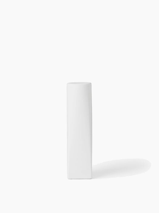A tall, white, sculptural Ignus Flameless Candle with a rectangular base and round top, pictured against a white background.