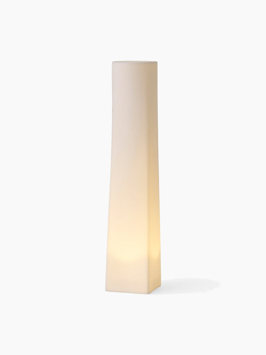 The tall, square-based Ignus Flameless Candle H35, lit from within, casting a soft, warm glow against a white background.