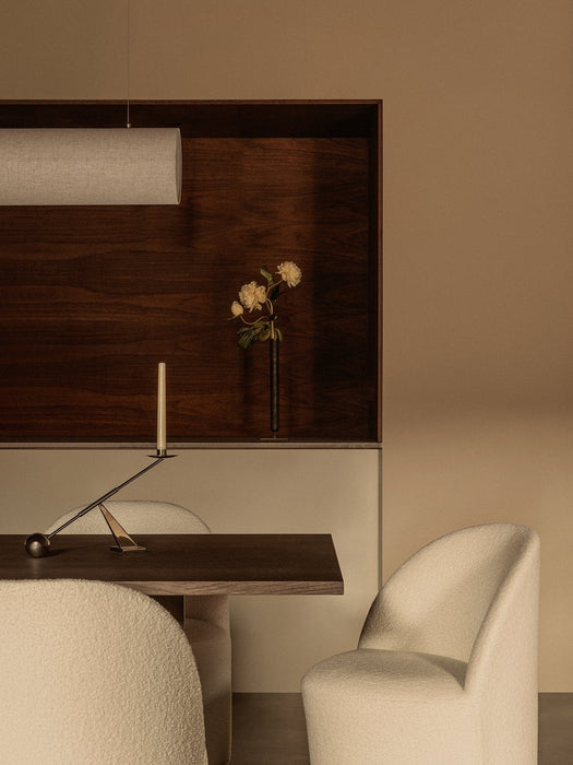 A dining setting with the Androgyne Table, white Tearoom Chairs, Interconnect Candle Holder, and a Hashira Linear pendant.