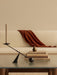 The black Interconnect Candle Holder on a glass-topped Brasilia Lounge Table, with the cream Brasilia Sofa in the background.