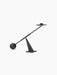 A sculptural dark bronze candlestick, its long arm balancing on a pyramidal base, with a sphere at one end and a holder.