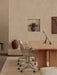 Androgyne Dining Table and Co Task Chairs in a beige room with an Interconnect Candle Holder, Passage Stool and vases.