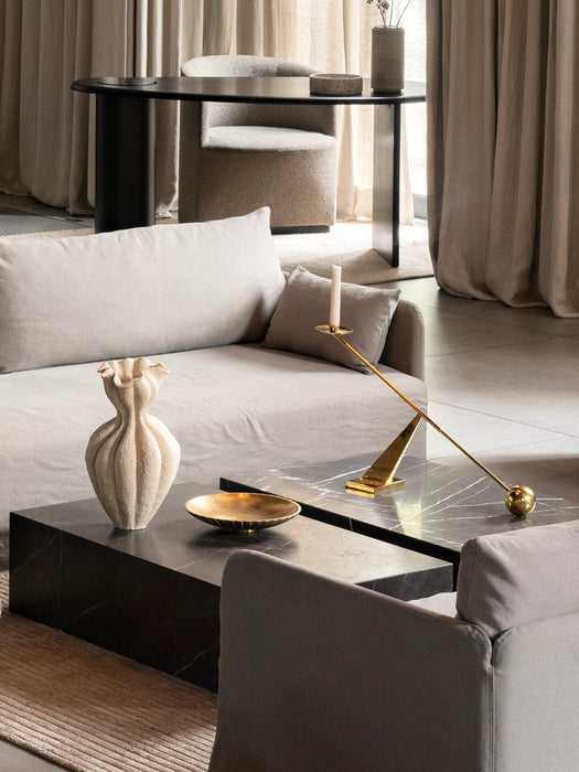 A living room featuring an Offset Loose Cover sofa, a Plinth table with an Interconnect Candle Holder, and a Brasilia chair.