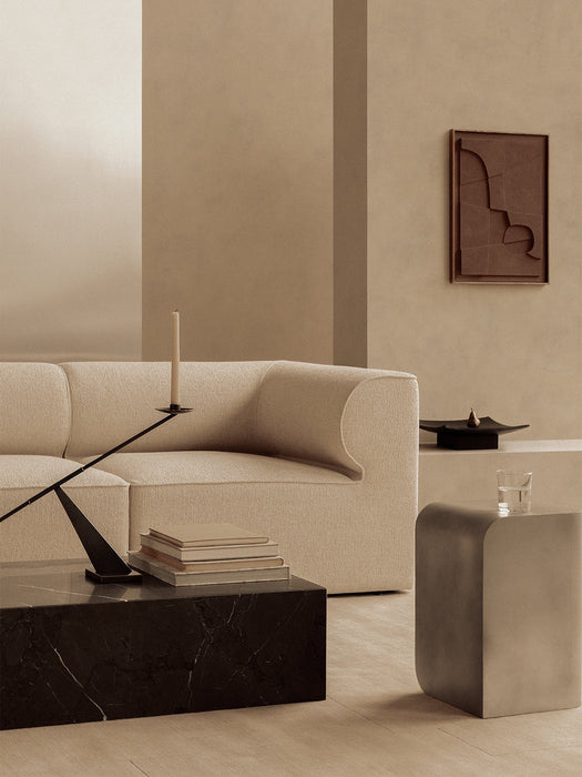 A beige Eave Modular Sofa, black marble Plinth Low coffee table, Interconnect Candle Holder, and a grey Volume Side Table
