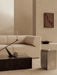 A beige Eave Modular Sofa, black marble Plinth Low coffee table, Interconnect Candle Holder, and a grey Volume Side Table