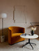 A JWDA Floor Lamp with a marble base stands in a stylish room next to a yellow velvet armchair and a round side table.