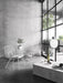 The JWDA Metallic Pendant Lamp hangs over a Plinth marble table. The minimalist room also features white String Chairs.