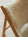 Close-up from above of the Knitting Lounge Chair, highlighting the plush sheepskin seat and the natural oak wood frame.