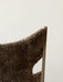 A close-up of the Knitting Lounge Chair in Sheepskin, showing the texture of the brown upholstery and the dark wood frame.