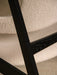 Close-up showing the textural contrast of the Knitting Lounge Chair's ivory bouclé seat and black oak frame.