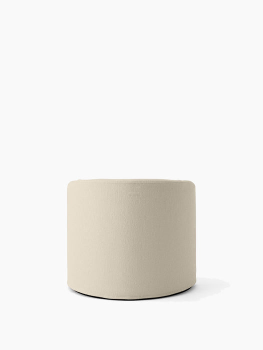 Back view of the cylindrical Tearoom Lounge Chair, upholstered in a light beige Logan Jasmin fabric on a white background.
