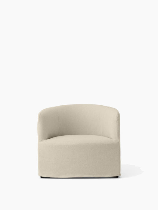 Front view of the Tearoom Lounge Chair, fully upholstered in a light beige Logan Jasmin fabric with a curved, low back.