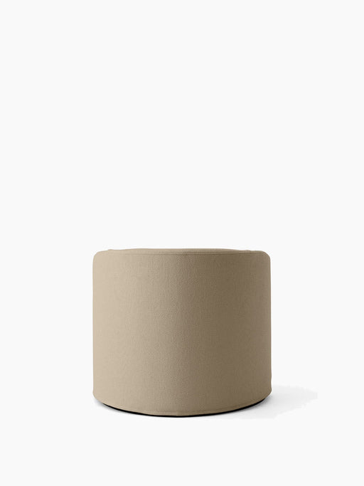 The Tearoom Pouf, a low, cylindrical seat upholstered in textured, sand-coloured Logan Sand fabric, on a white background.