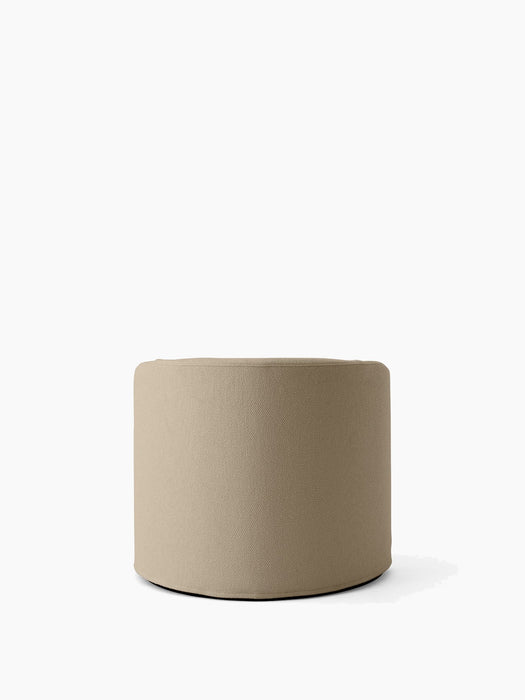 The Tearoom Pouf, a low, cylindrical seat upholstered in textured, sand-coloured Logan Sand fabric, on a white background.