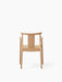 Back view of the Merkur Dining Chair with Armrests in natural oak, showing the curved backrest, arms, and slender legs.