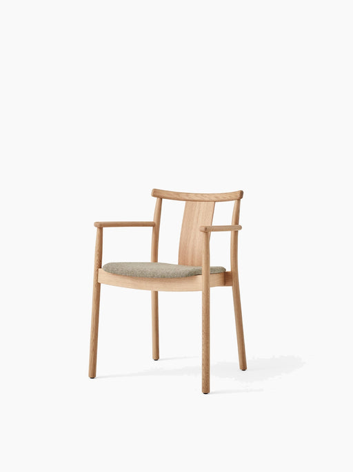 Merkur Dining Chair w/Armrests in natural oak and a light green upholstered seat, angled on a white background.