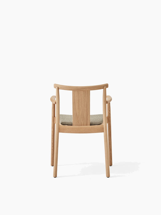 Back view of the Merkur Dining Chair with Armrests in natural oak, with a light grey upholstered seat and a white background.
