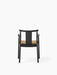 Back view of the Merkur Dining Chair with Armrests, featuring a black oak frame and a seat upholstered in Audo Bouclé 06.