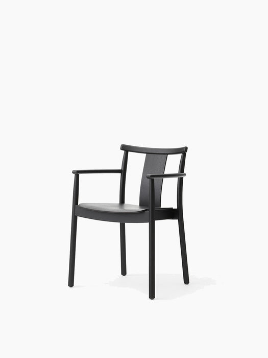 The Merkur Dining Chair with Armrests, constructed from black oak, shown from a three-quarter view on a white background.