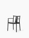 The Merkur Dining Chair with Armrests, constructed from black oak, shown from a three-quarter view on a white background.