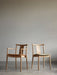 Two Merkur Dining Chairs in natural oak. One has armrests and a leather seat, the other has a fabric seat and no armrests.