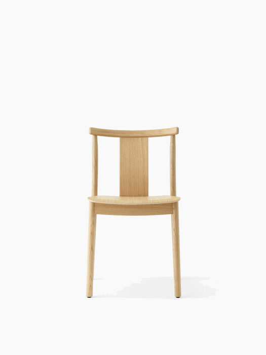 Front view of the Merkur Dining Chair in natural oak, showing its minimalist design with a curved backrest and four legs.