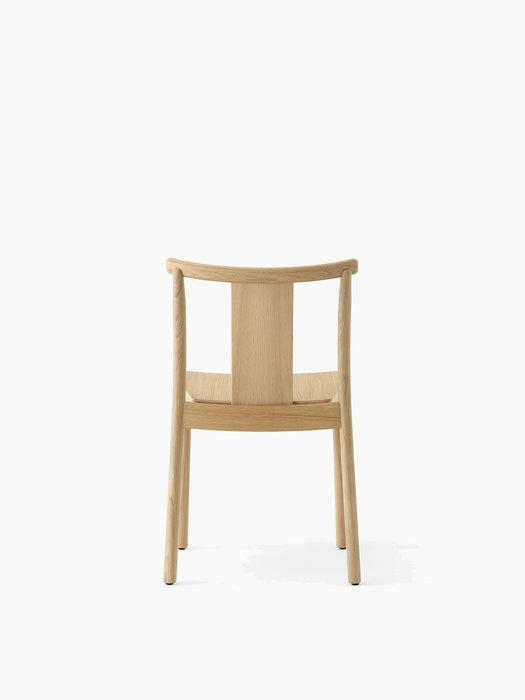 Back view of the Merkur Dining Chair in natural oak, showing its simple wooden frame, curved top rail, and central back slat.
