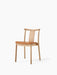 Angled view of the Merkur Dining Chair. It has a natural oak frame with a light brown leather seat, on a white background.
