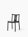 An angled view of the Merkur Dining Chair in black oak, shown against a white background. The chair has a minimalist design.