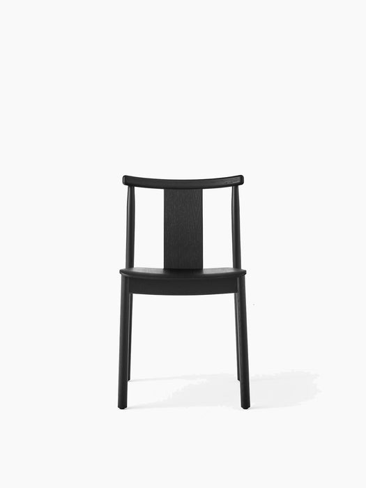 Front view of the Merkur Dining Chair in black oak. The wooden chair has a curved backrest with a central vertical slat.