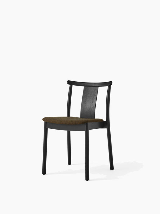 Angled view of the Merkur Dining Chair with a black oak frame and a dark green, textured upholstered seat.