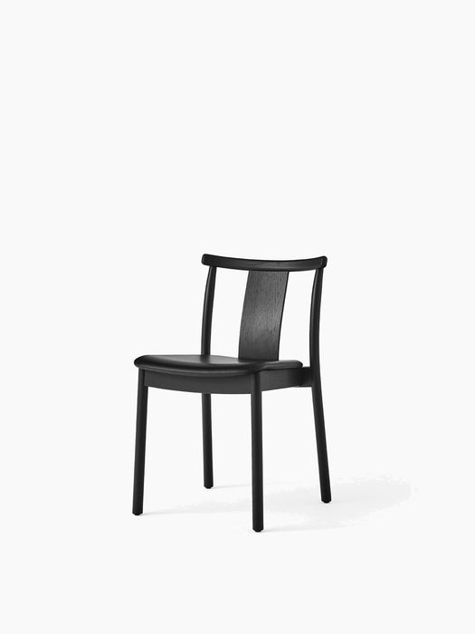 Merkur Dining Chair in black oak with a black leather upholstered seat, viewed from a slight angle.