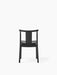 Back view of the Merkur Dining Chair in black oak, showing its curved top rail, wide central back splat, and slim legs.