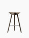 Front view of the ML 42 Bar Stool with a sculptural seat, three dark smoked oak legs, and a steel footrest.