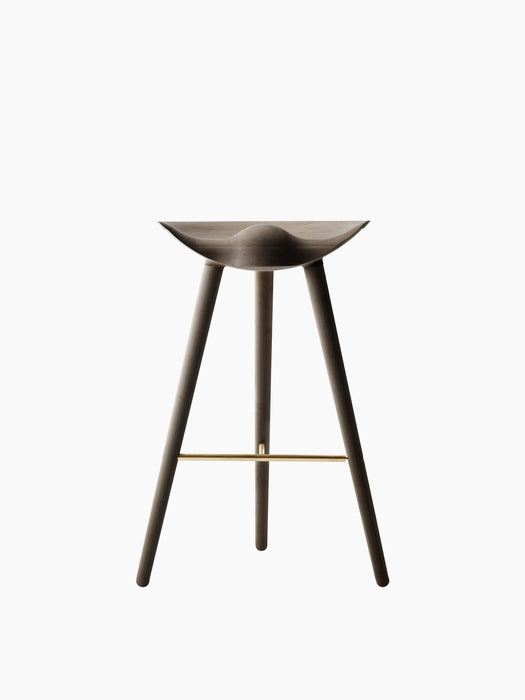 Front view of the sculptural, three-legged ML 42 Bar Stool in smoked oak with a brass footrest on a white background.